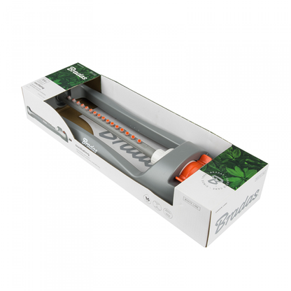 Sprinkler in retail box packaging, gray body with orange control dial visible