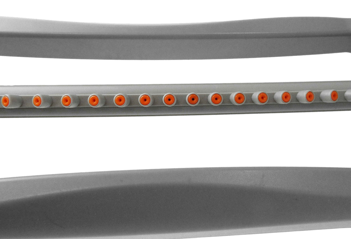 Close-up of gray oscillating sprinkler spray bar showing orange outlet ports
