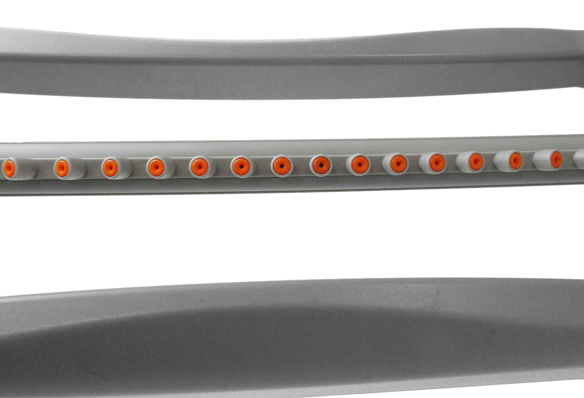 Close-up of gray oscillating sprinkler spray bar showing orange outlet ports