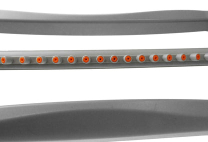 Close-up of gray oscillating sprinkler spray bar showing orange outlet ports