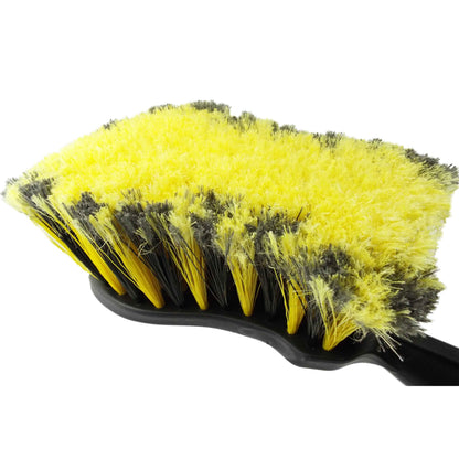 Close-up of yellow and black bristles on car cleaning brush head