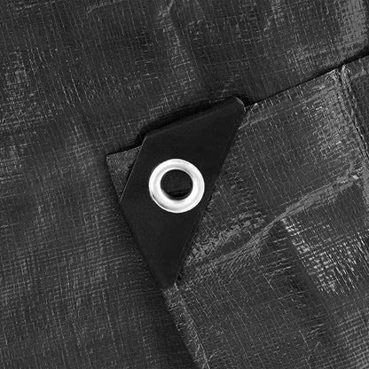 Reinforced corner patch with round silver grommet on black tarpaulin