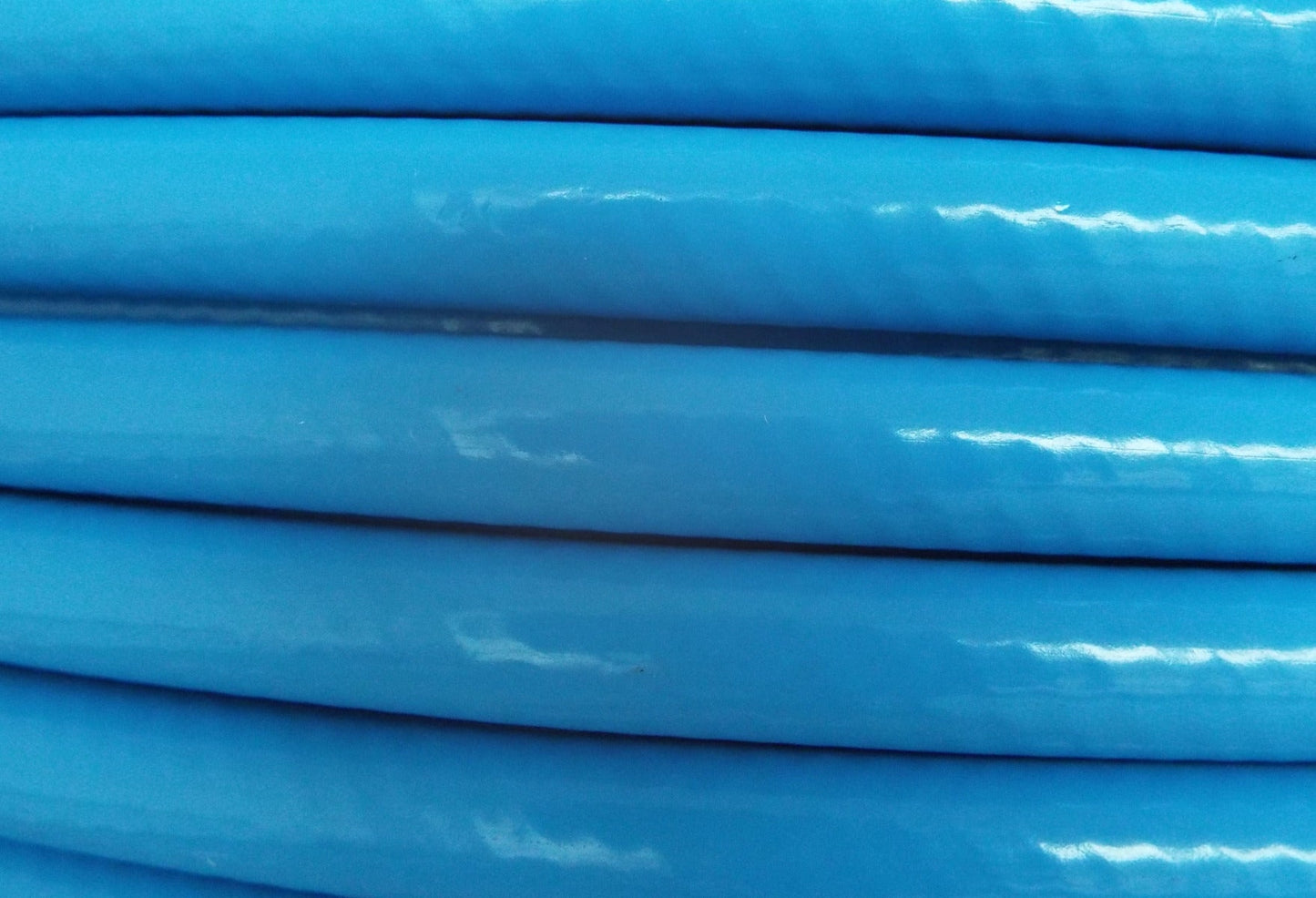 Blue water hose pipe, close-up of the ribbed outer surface