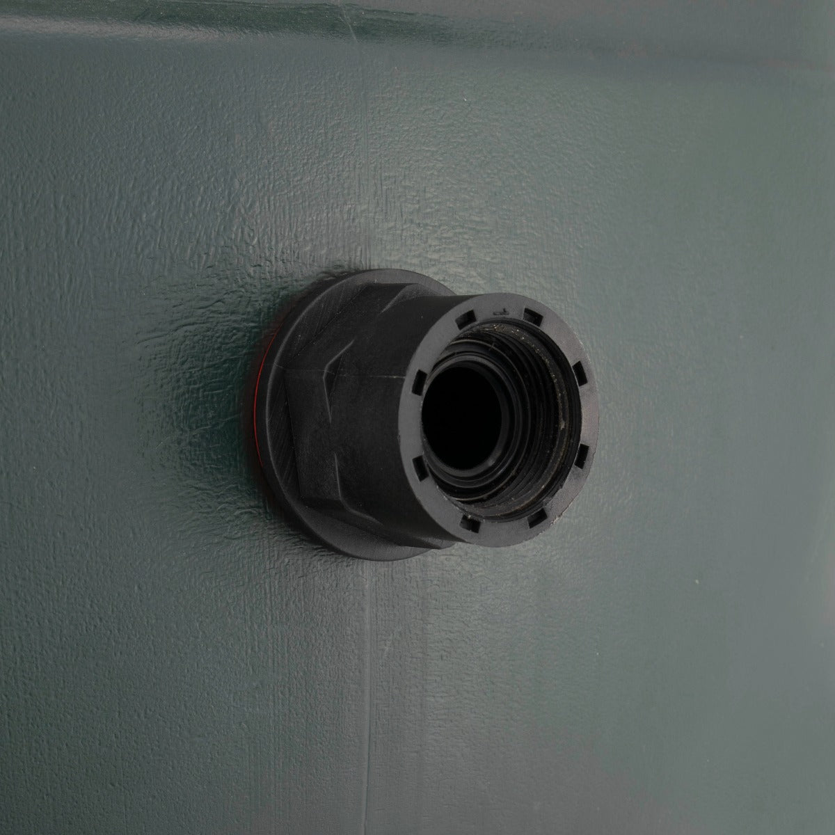 Close-up of black threaded outlet and red seal on water butt connector