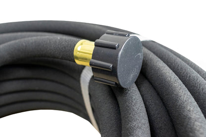 Soaker hose connector fitting on black porous hose line