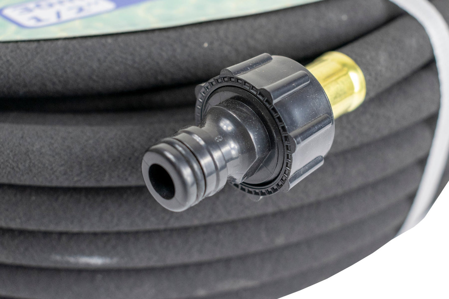 Soaker hose end connector with brass insert and dark coupling