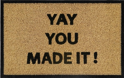 Beige coir doormat reading “YAY YOU MADE IT!” in black lettering