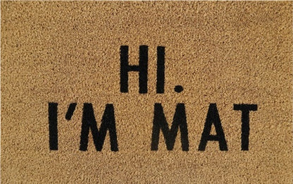 Doormat close-up: 'Hi. I'm Mat' lettering in black on tan coir