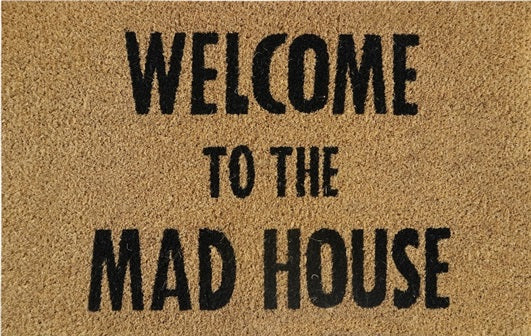 Beige doormat reading 'WELCOME TO THE MAD HOUSE' in black letters