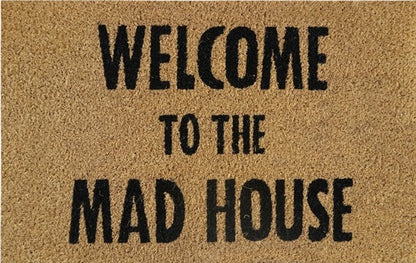 Beige doormat reading 'WELCOME TO THE MAD HOUSE' in black letters