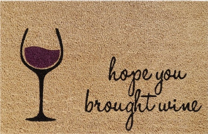 Doormat with wine glass and handwritten style 'hope you brought wine'