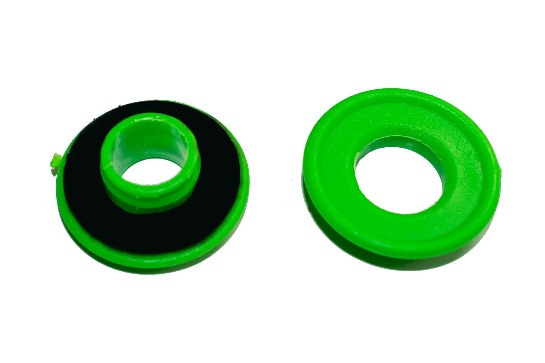 Green tarp eyelet with black backing ring, close-up front view
