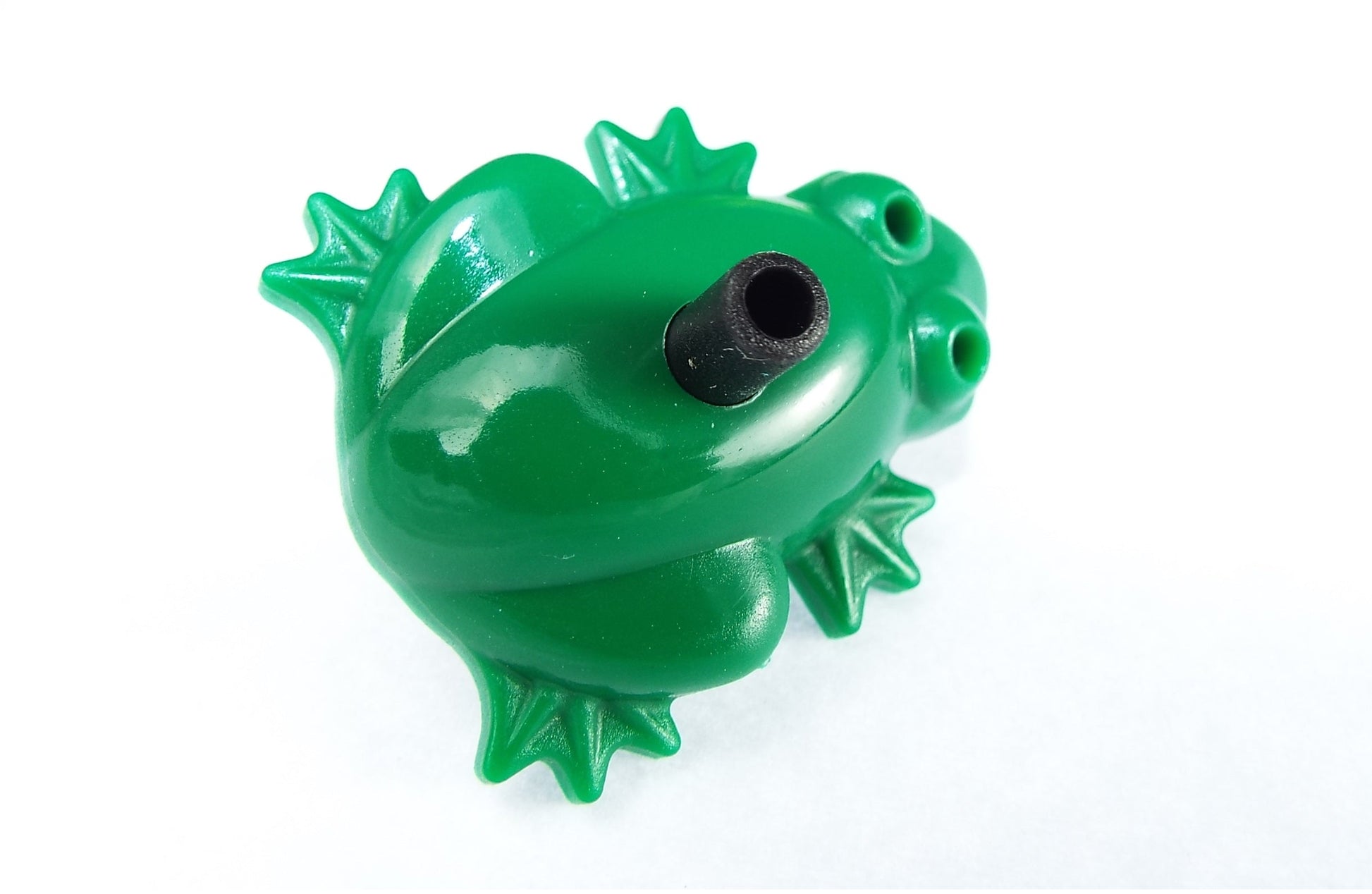 Green frog drip emitter with black center spout and side water outlet