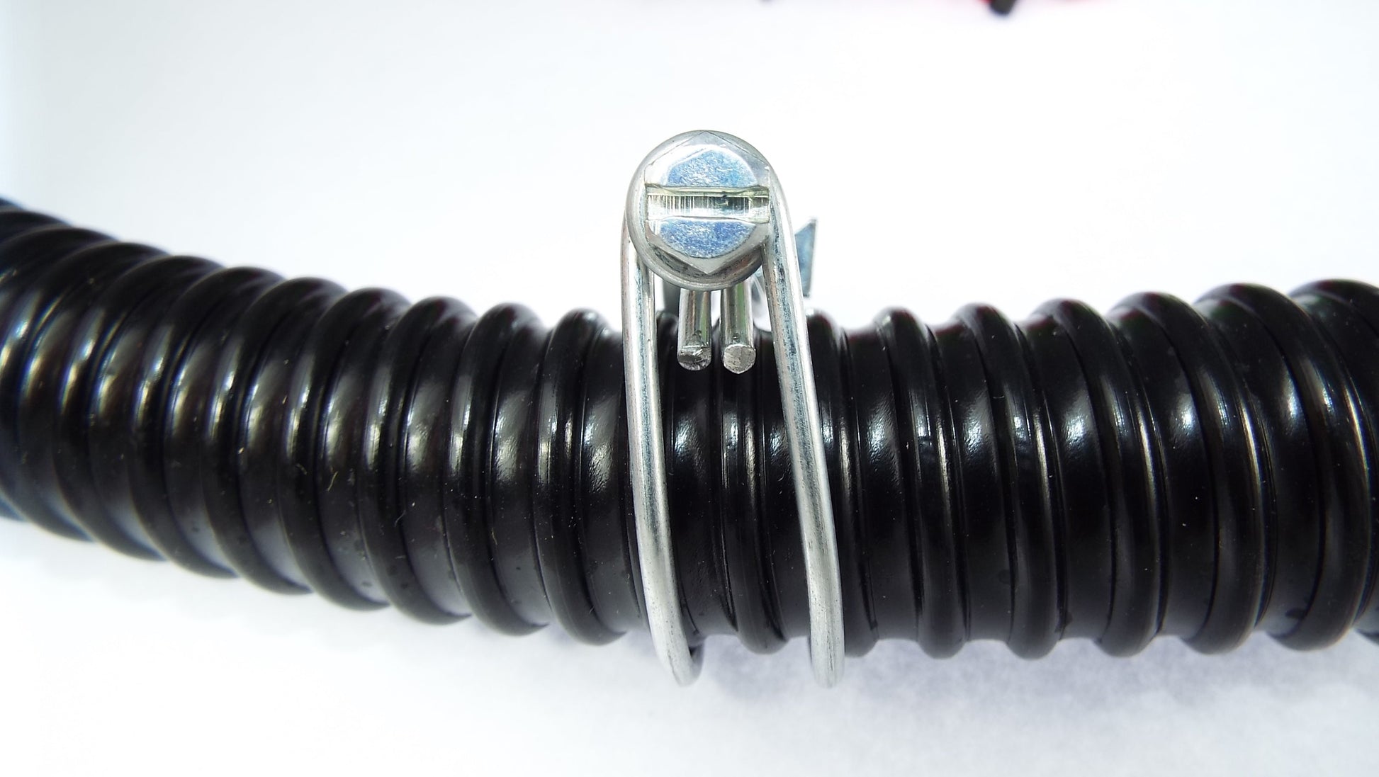Galvanised double wire hose clamp with screw housing on black corrugated hose