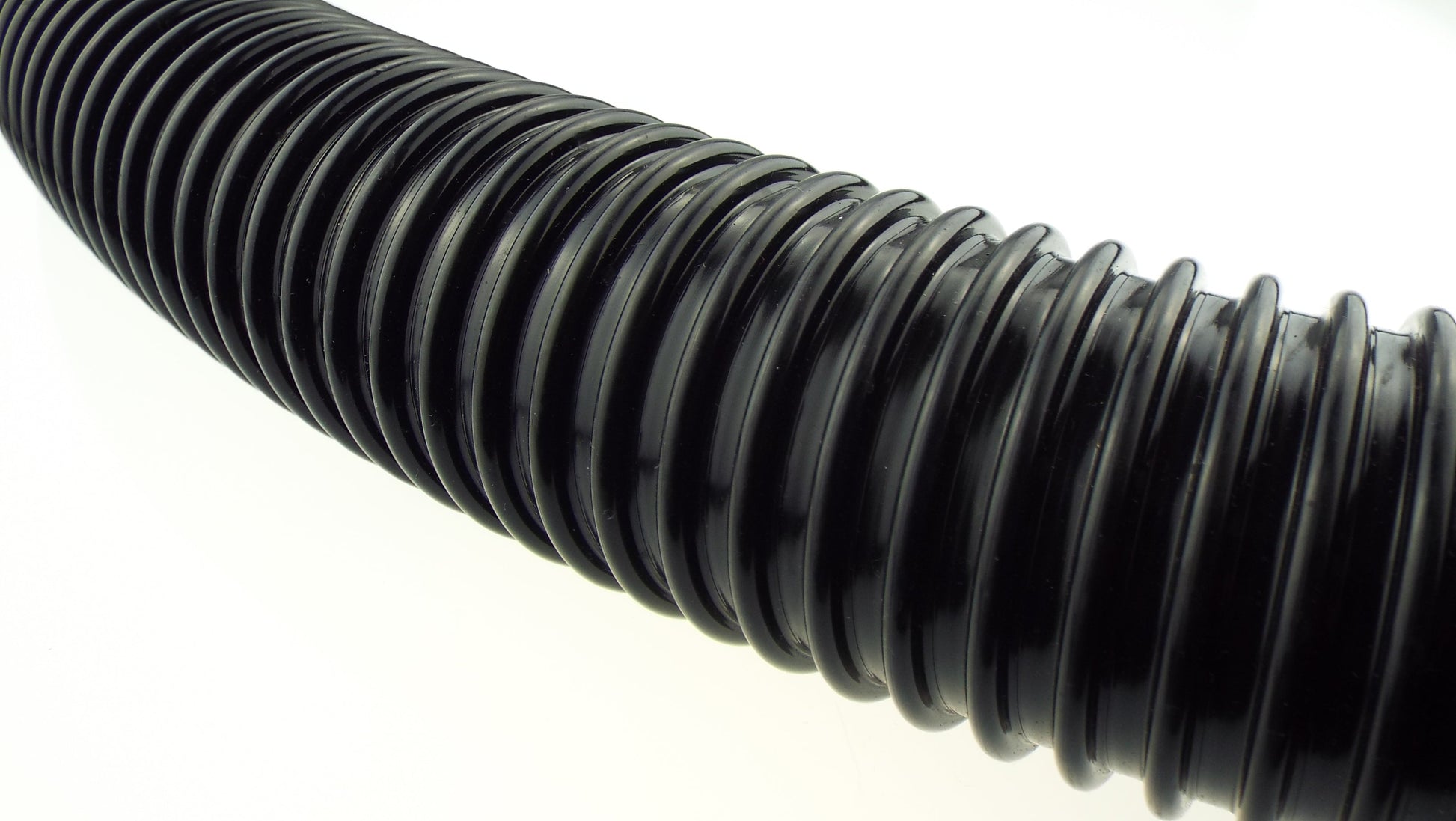 Close-up of black corrugated ribbed pipe with grooves along the length