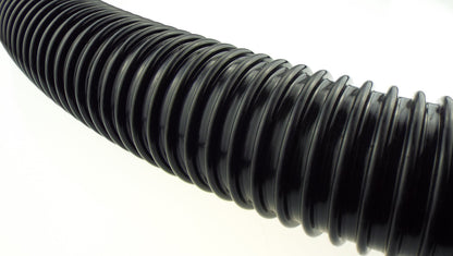 Close-up of black corrugated pipe ridges along the length