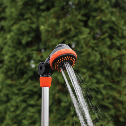 Fan spray from orange shower head on metal garden stake, adjustable nozzle