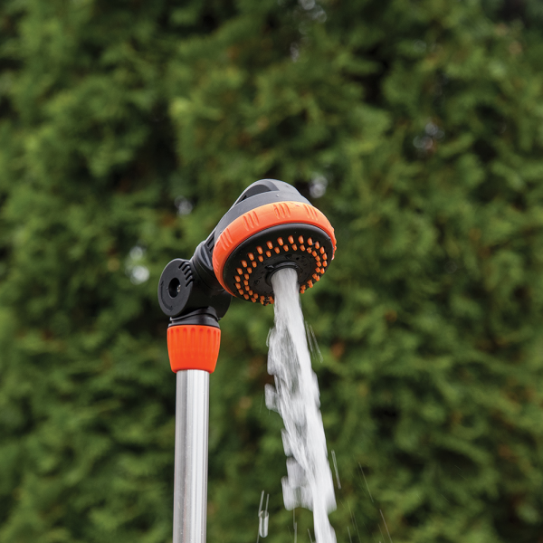 Water stream from orange shower head on metal spike stake