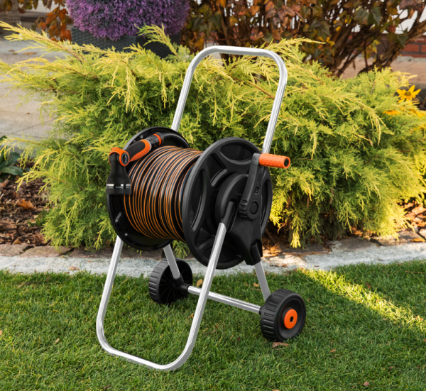 Hose reel cart with neatly coiled black hose, orange crank, black transport wheels