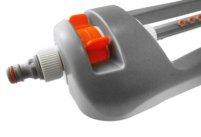 Gray oscillating sprinkler with orange adjustment dial near the water connector