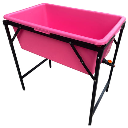 Pink dog bath with drain valve and black metal stand, rectangular tub shape