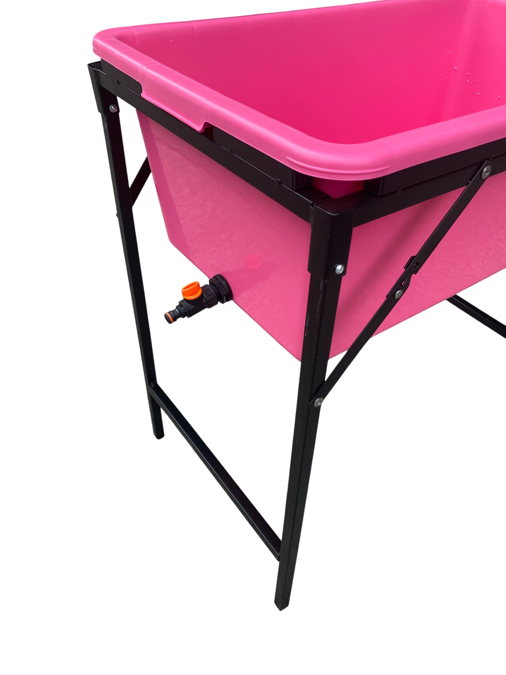Pink dog bath with black stand and side drain tap