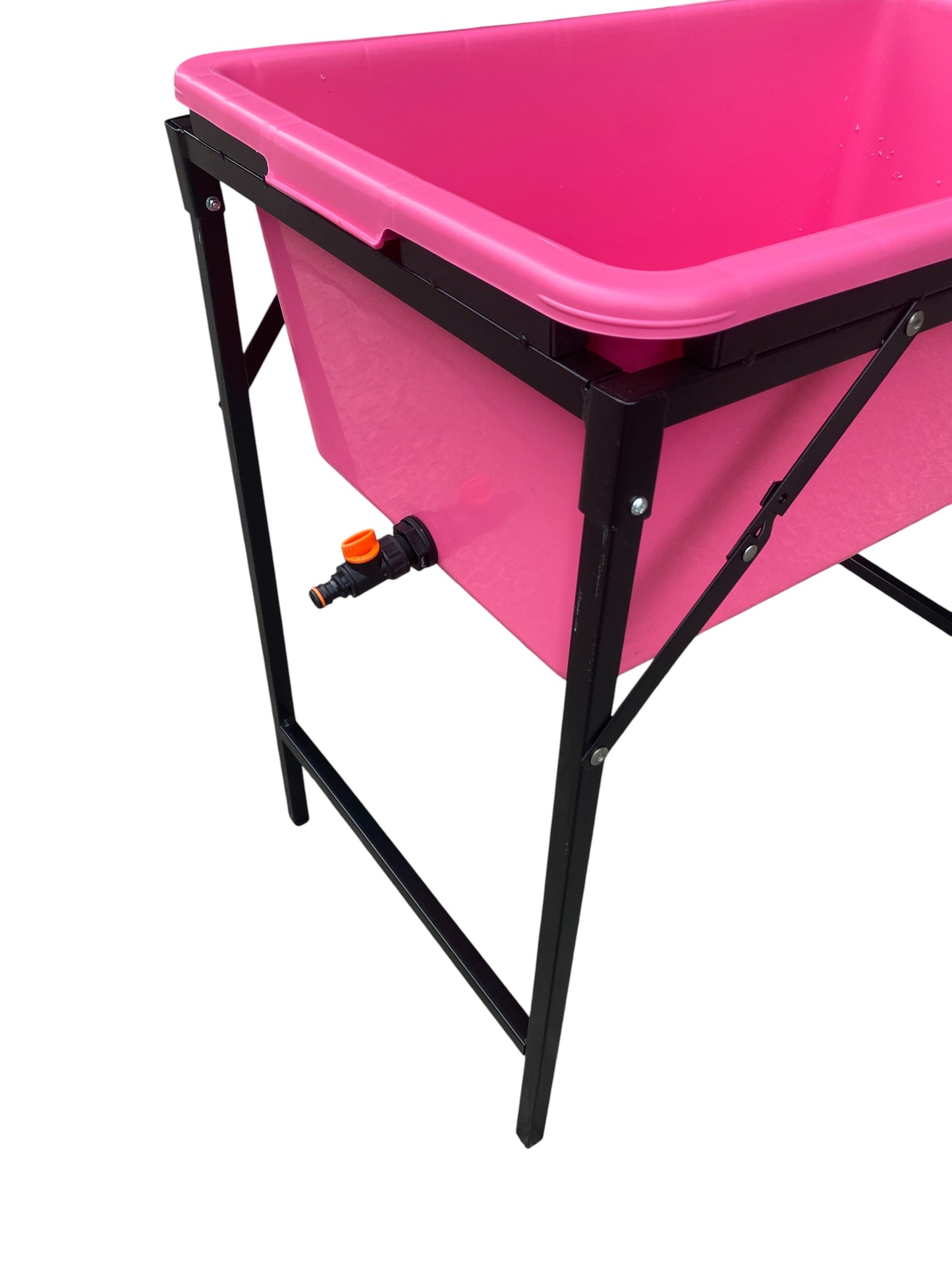 Pink bathing tub on black frame with drain valve