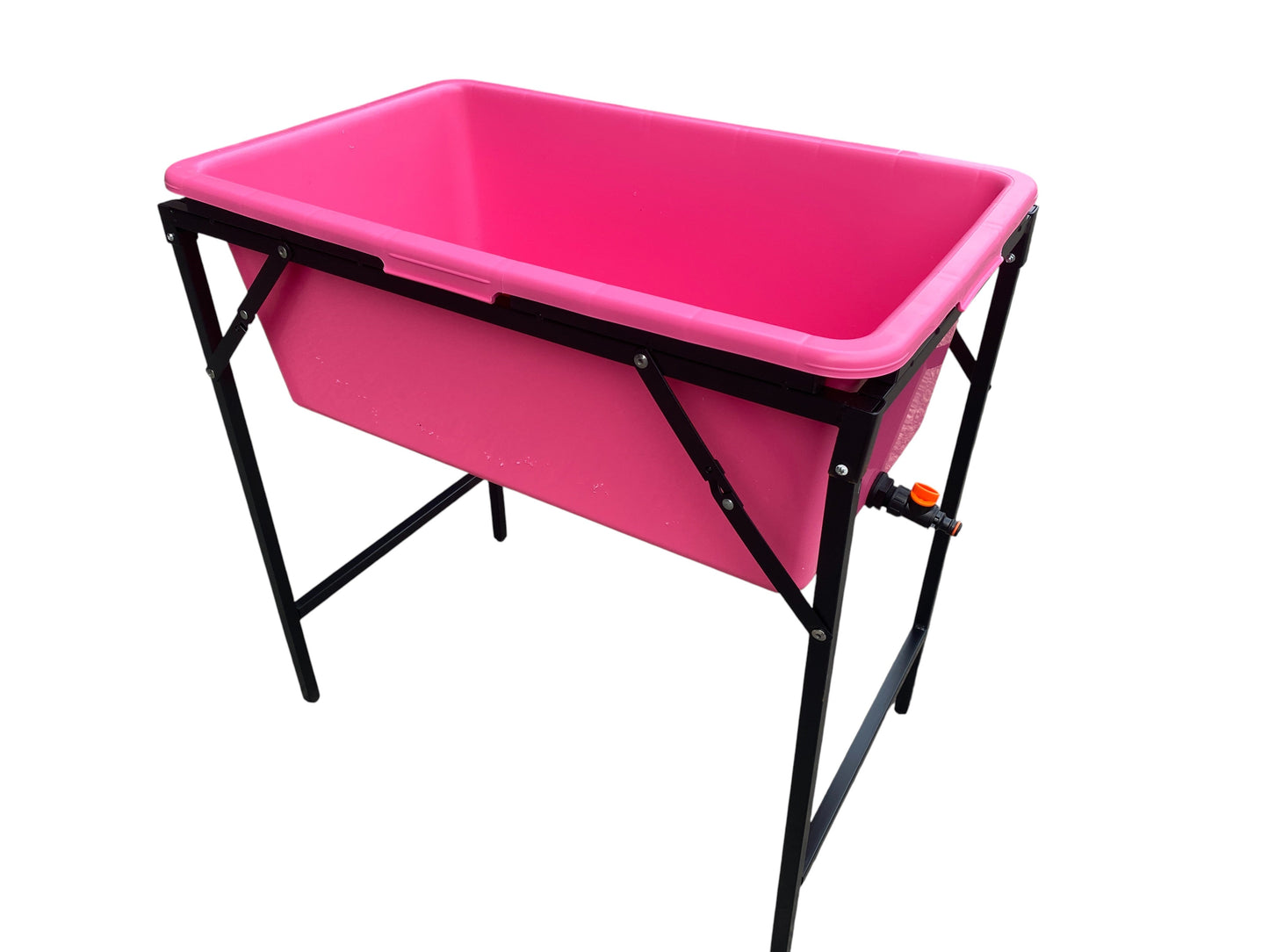 Pink dog bath on black folding stand with drain valve