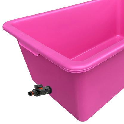 Pink dog bath with molded rim, drain channel, and black valve outlet