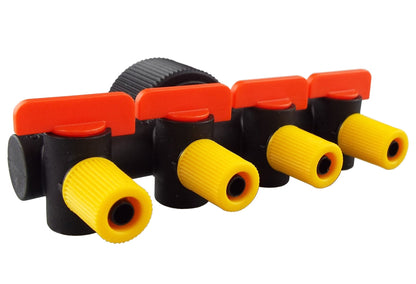 Side view of 4-way manifold: yellow barbed outlets with red valve caps on black body