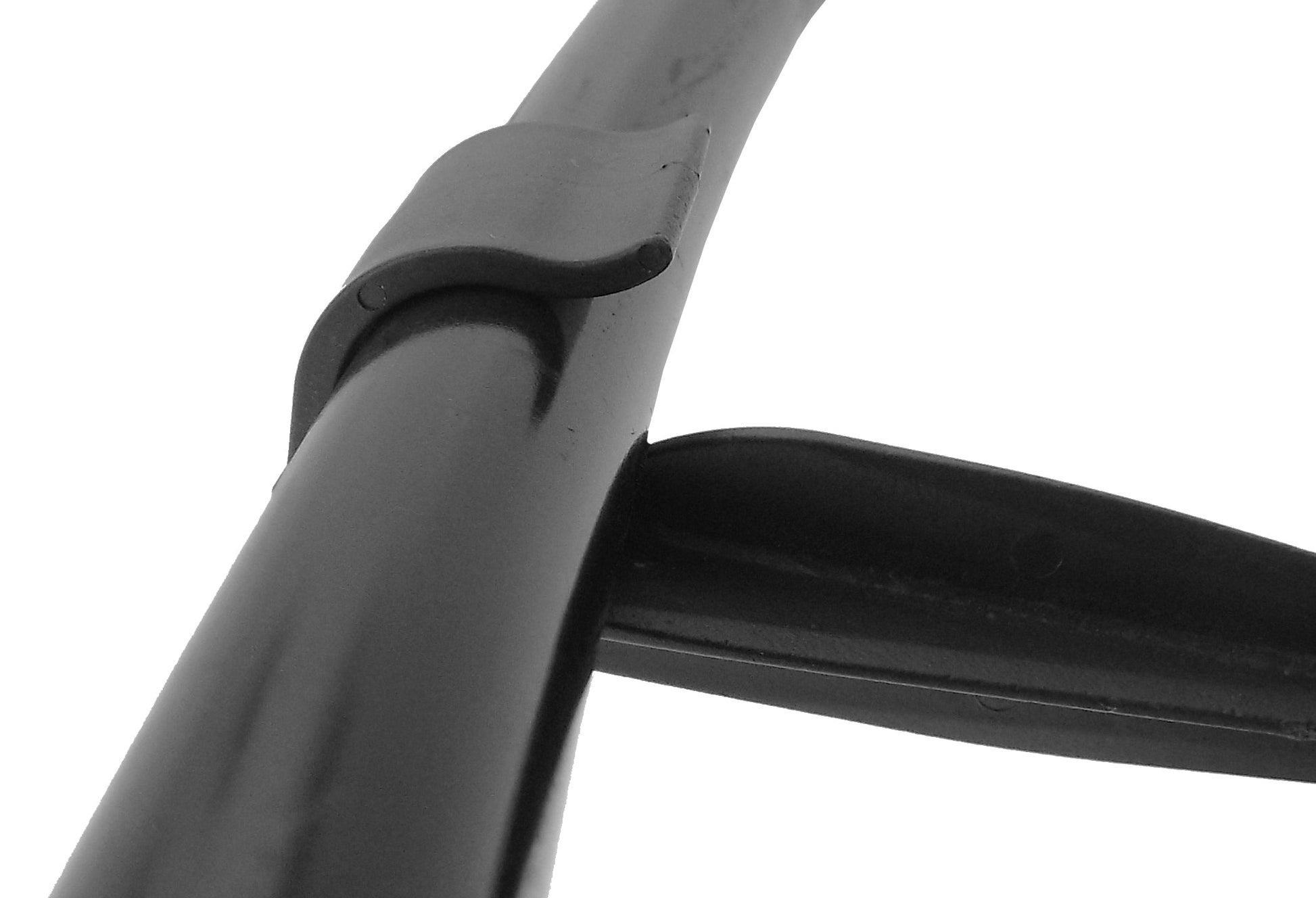 Close-up of black stake clamp holding a 16mm irrigation pipe