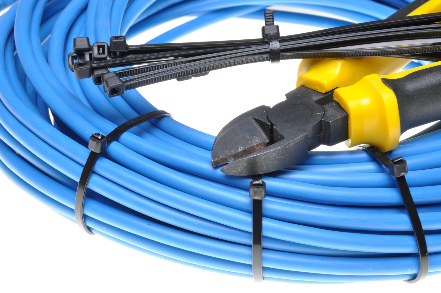Close-up of black cable ties fastening cables with ratchet locking heads