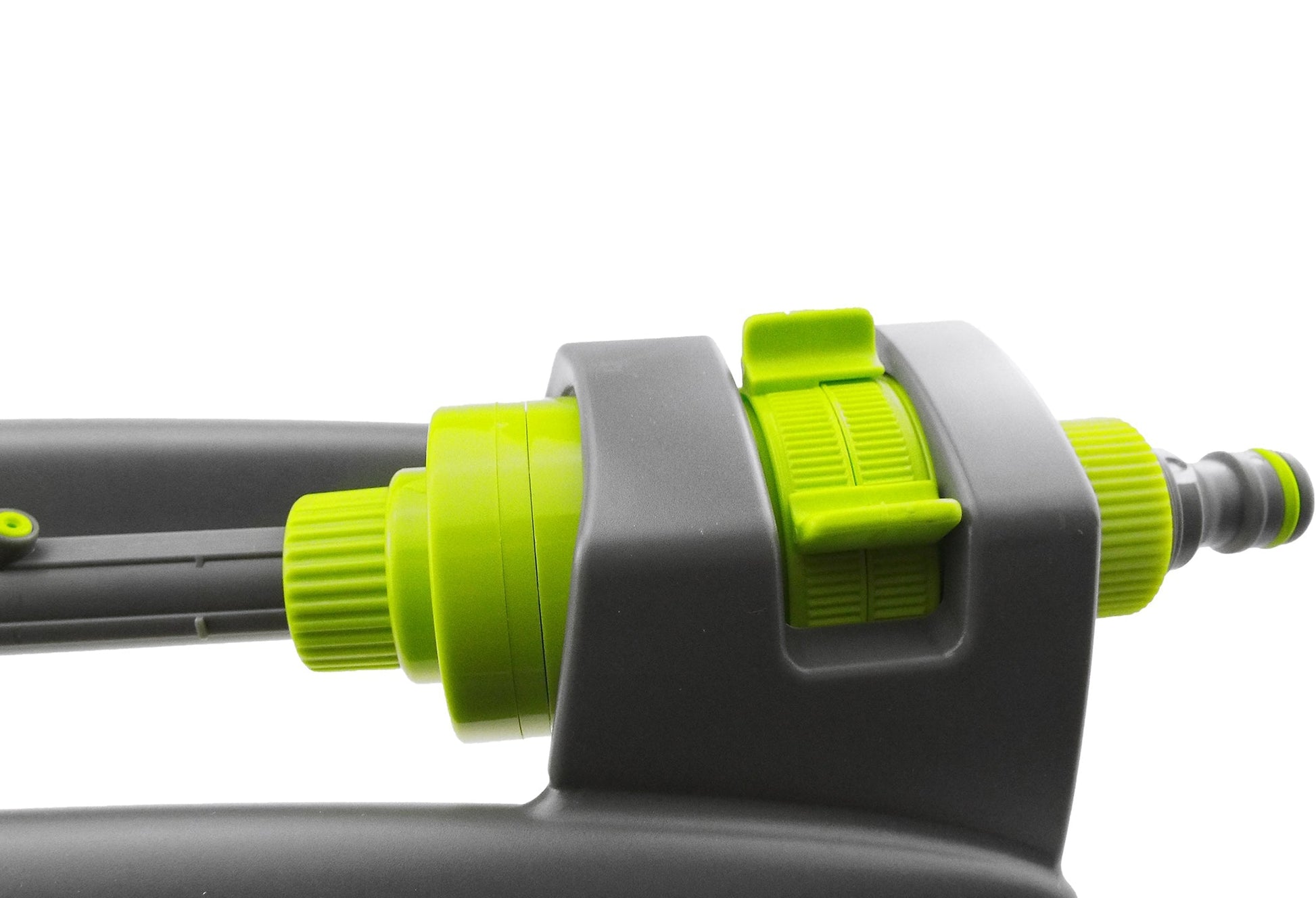 Close-up of lime-green adjustment knob on grey oscillating sprinkler body