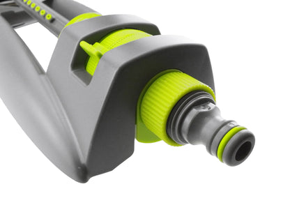 Close-up of lime-green end fitting and black outlet on oscillating sprinkler