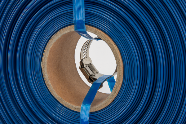 Coiled blue flat lay hose with metal clip fastener at core
